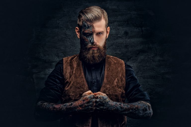 Portrait Of A Scary Bearded Male With Burning Make.