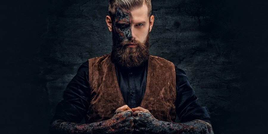 Portrait Of A Scary Bearded Male With Burning Make.