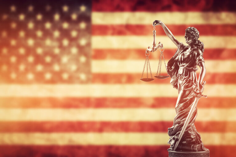 Law concept. Themis statue against USA flag. Symbol of justice,