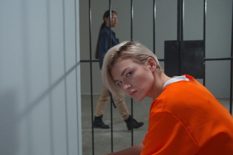 Prison For Women. The Criminal Is Sitting In His Cell