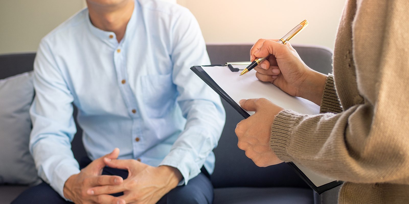 Male Patient Having Consultation With Doctor Or Psychiatrist Wor