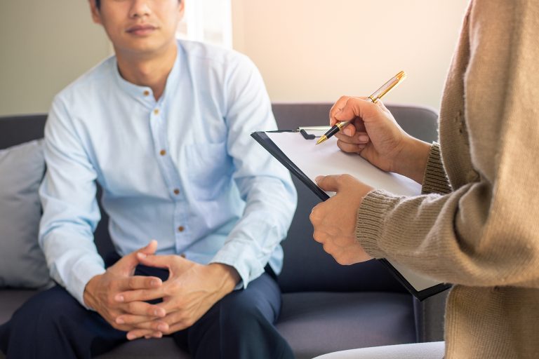 Male Patient Having Consultation With Doctor Or Psychiatrist Wor