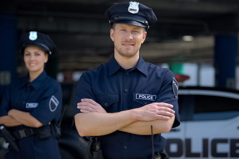 Kind Police Officers Smiling Standing Near Police Station, Ready
