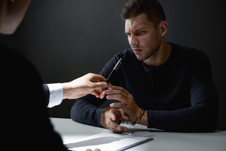 Criminal Man In Interrogation Room Being Interrogated And Refusi